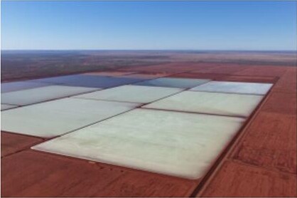 Aerial view of rectangular salt crystalliser ponds at the Mardie Salt Operation, with pale brine-filled cells set in red-brown coastal terrain.