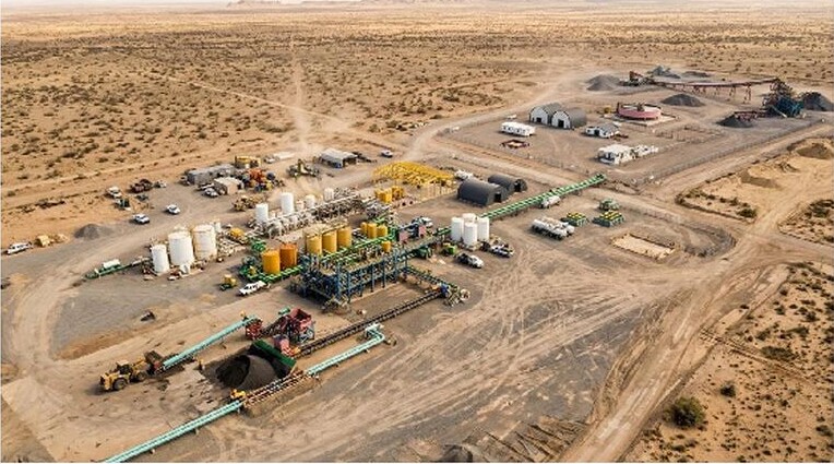 Conceptual 3D rendering of the planned Tiris permanent process plant, showing processing equipment, tanks, access roads and surrounding desert terrain.