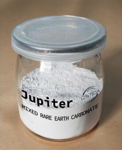 A sealed jar labelled Jupiter Mixed Rare Earth Carbonate containing a pale powdered representative MREC sample.