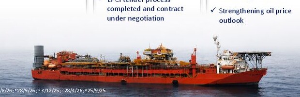 An offshore floating production vessel with a red hull operating at sea.