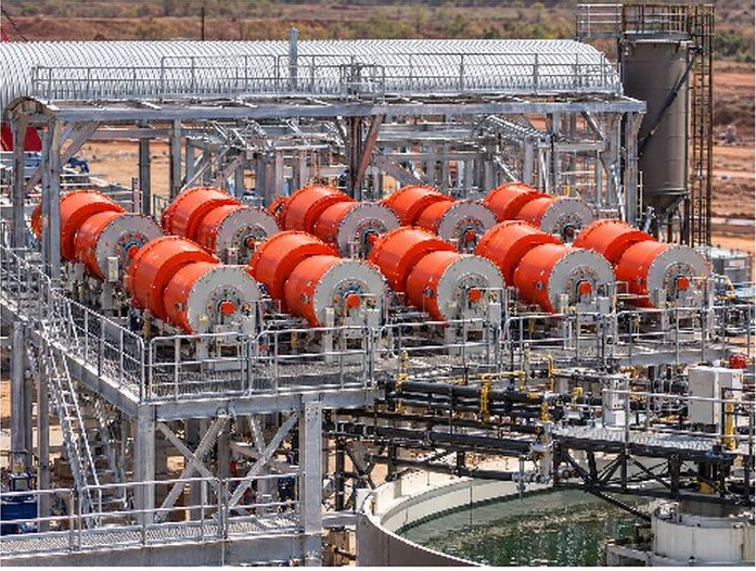 Kangankunde process plant separation circuits with rows of orange processing units, steelwork, piping and a water tank.